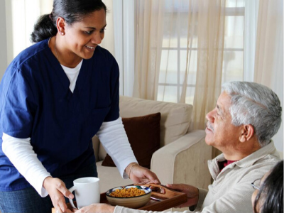 Nurse proving food to elderly patient