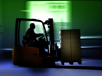 Operator carries boxes on a forklift