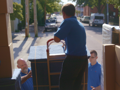 3 men loading boxes into a truck