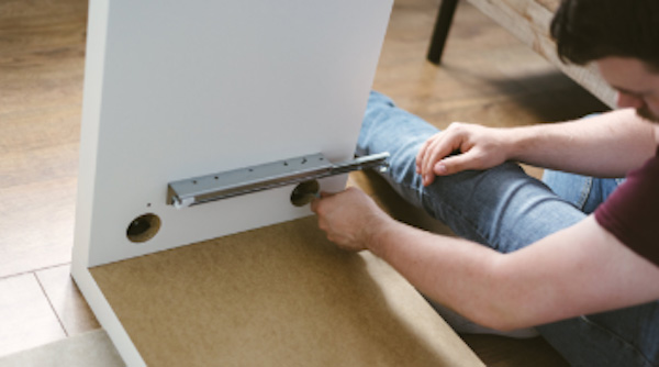 man-assembling-furniture-in-model-homes